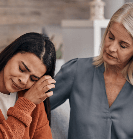 A young brunette woman being consoled by her therapist