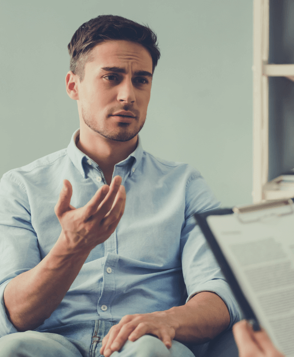 A man expressing himself with a gesture during therapy