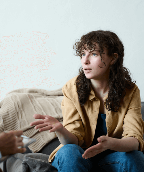 Woman sitting and talking to her rehab therapist