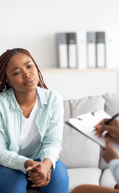 Young woman looking at a therapist during a free mental health and addiction assessment